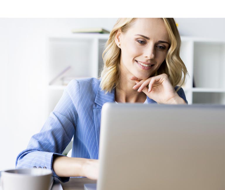 Smiling professional woman working on laptop